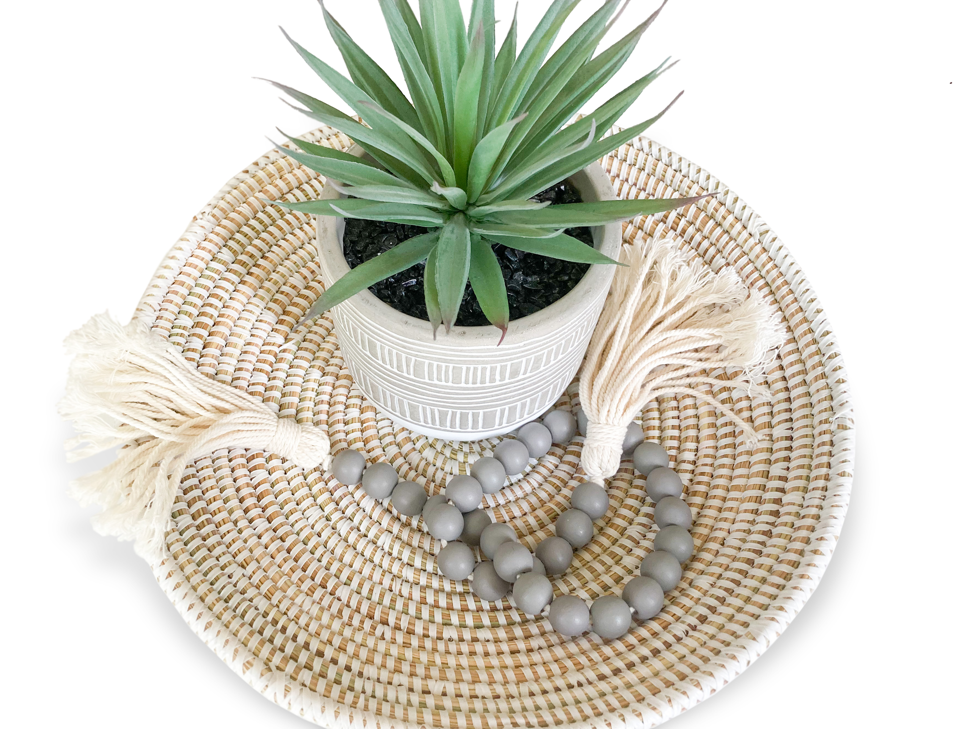 small tabletop basket with group of decor items: faux plant and wooden beads